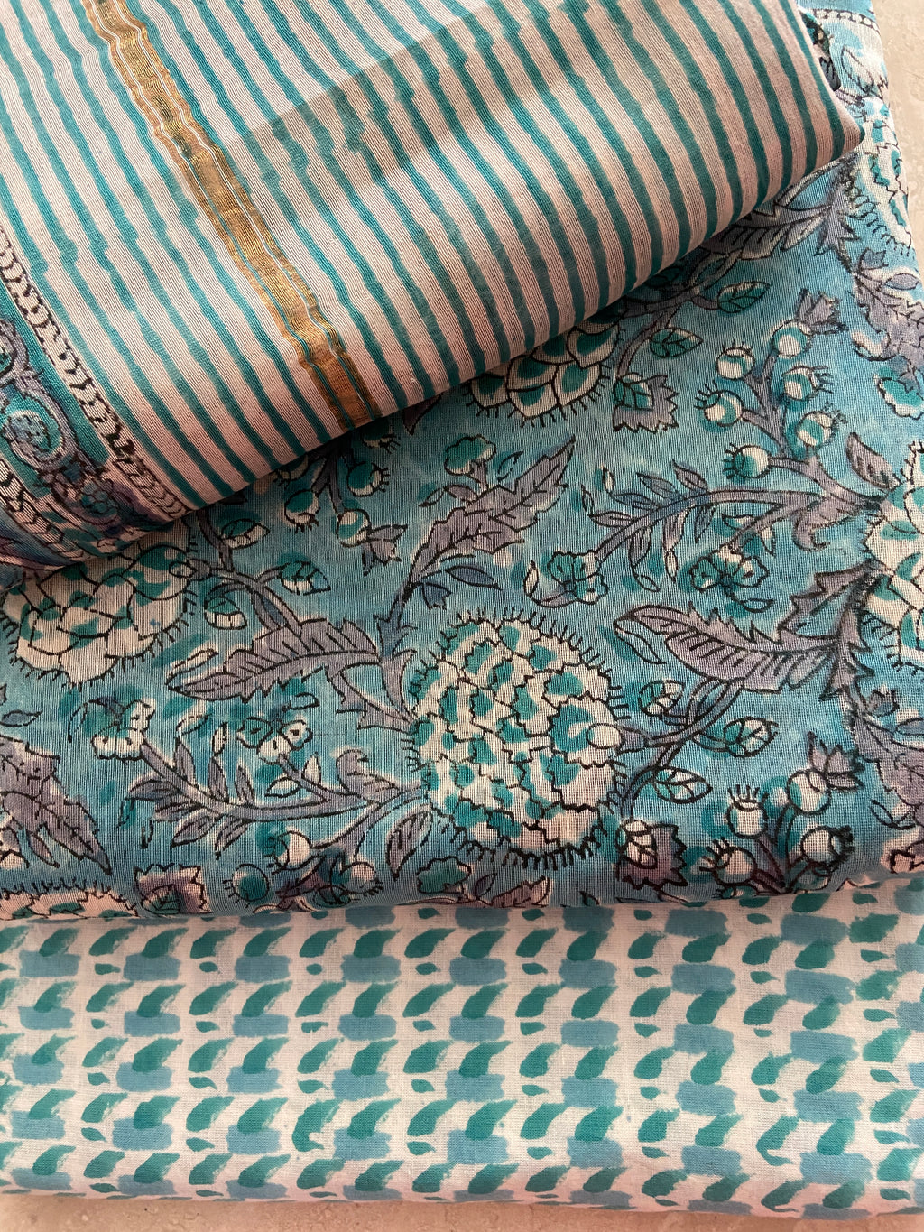 Close-up of Peacock Blue Chanderi kurta fabric showing dense padded geometric motifs in cream and gold on rich peacock blue base - traditional three-dimensional handloom weaving technique, Madhya Pradesh | Bloomton Designs
